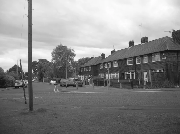 several people and trucks parked on the side of the street