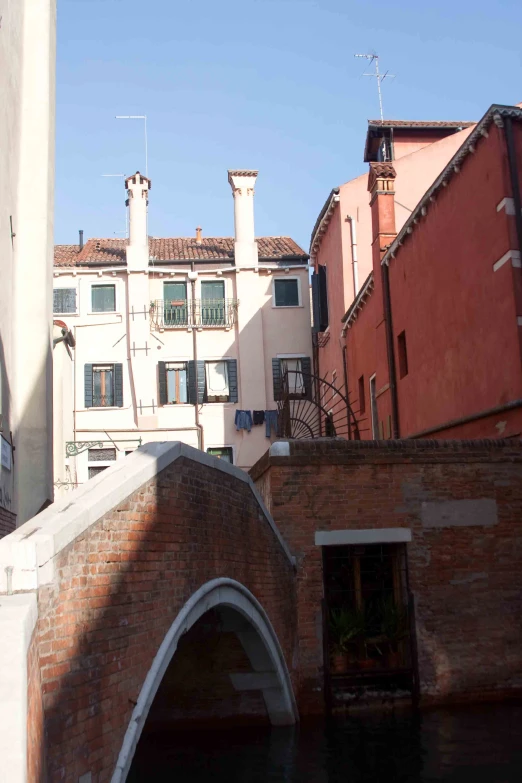 some very old buildings by a bridge in a city