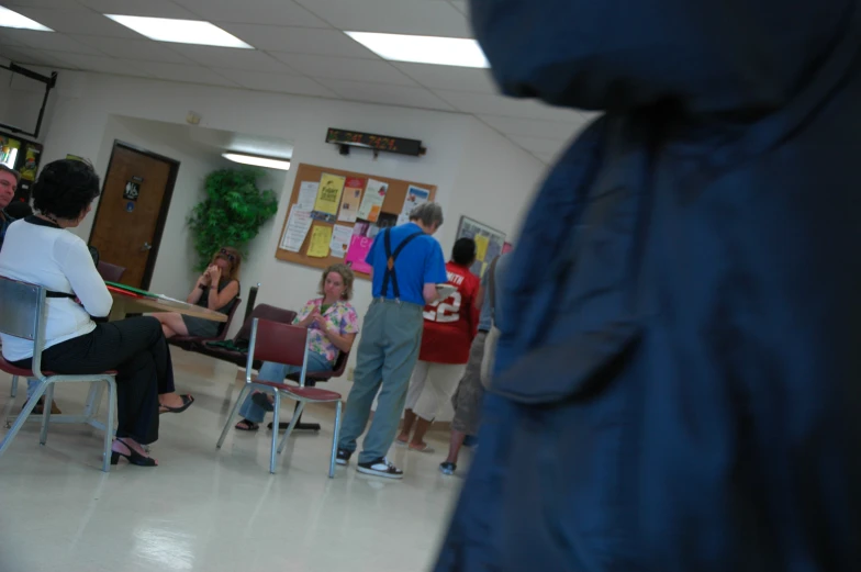 people in a classroom with a door open