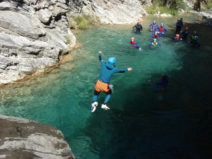 a man is standing in some water with a ball