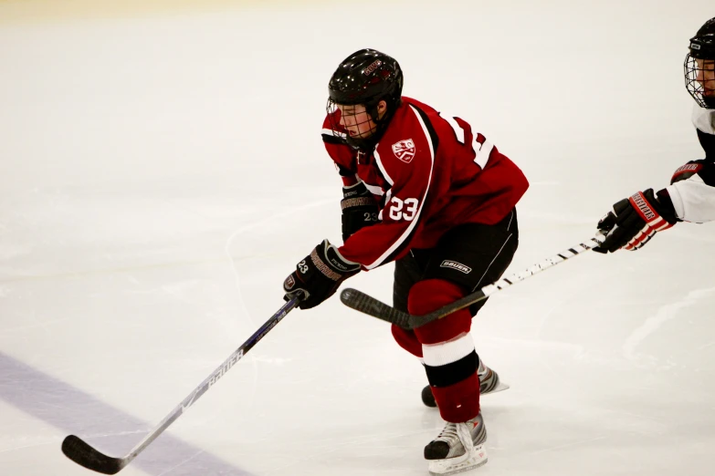 a hockey player with his hand on the hockey stick