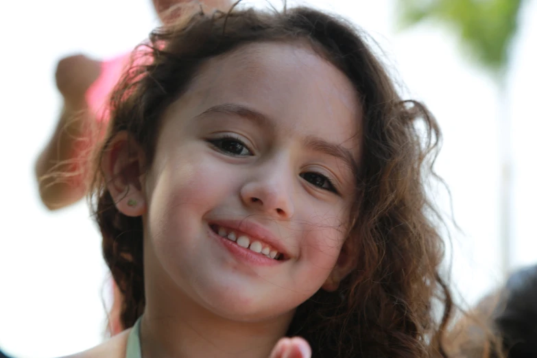 a close up of a child's face and hair