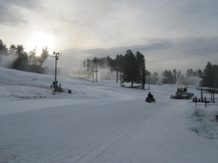 a person riding on a motorcycle in the snow