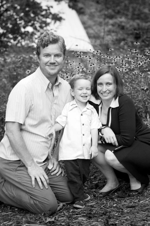 a family poses for a black and white po