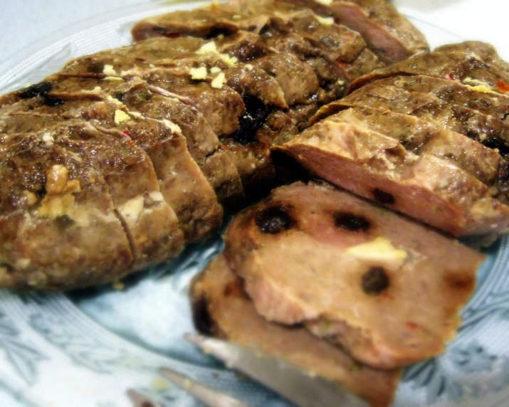 a plate topped with meat and bread