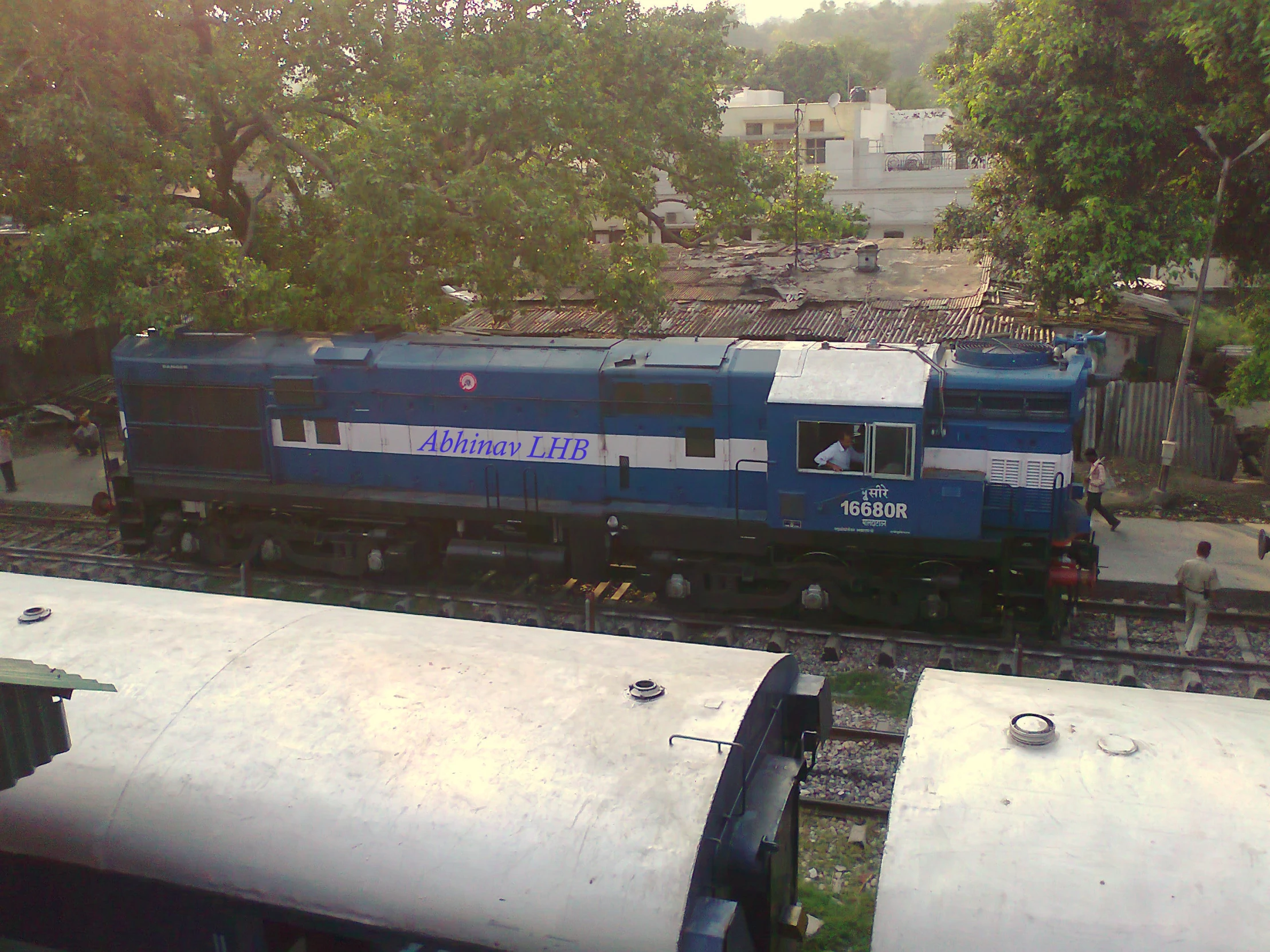 an old train sits on the tracks near some water