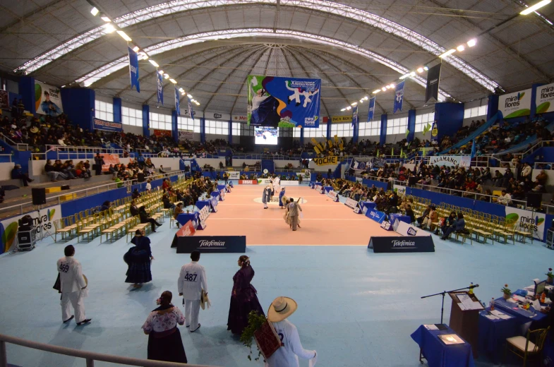 many people are shown in a huge gym