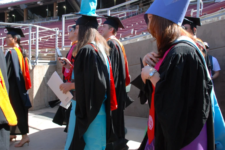 group of students standing in line wearing graduation gowns