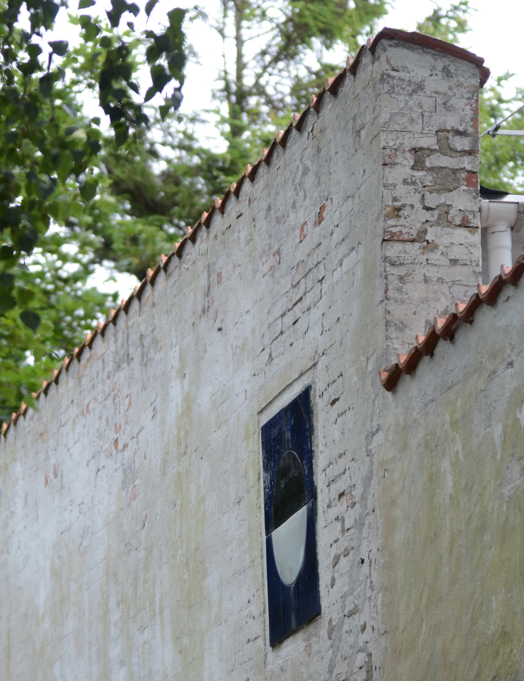 there is a window and tiled roof on this house