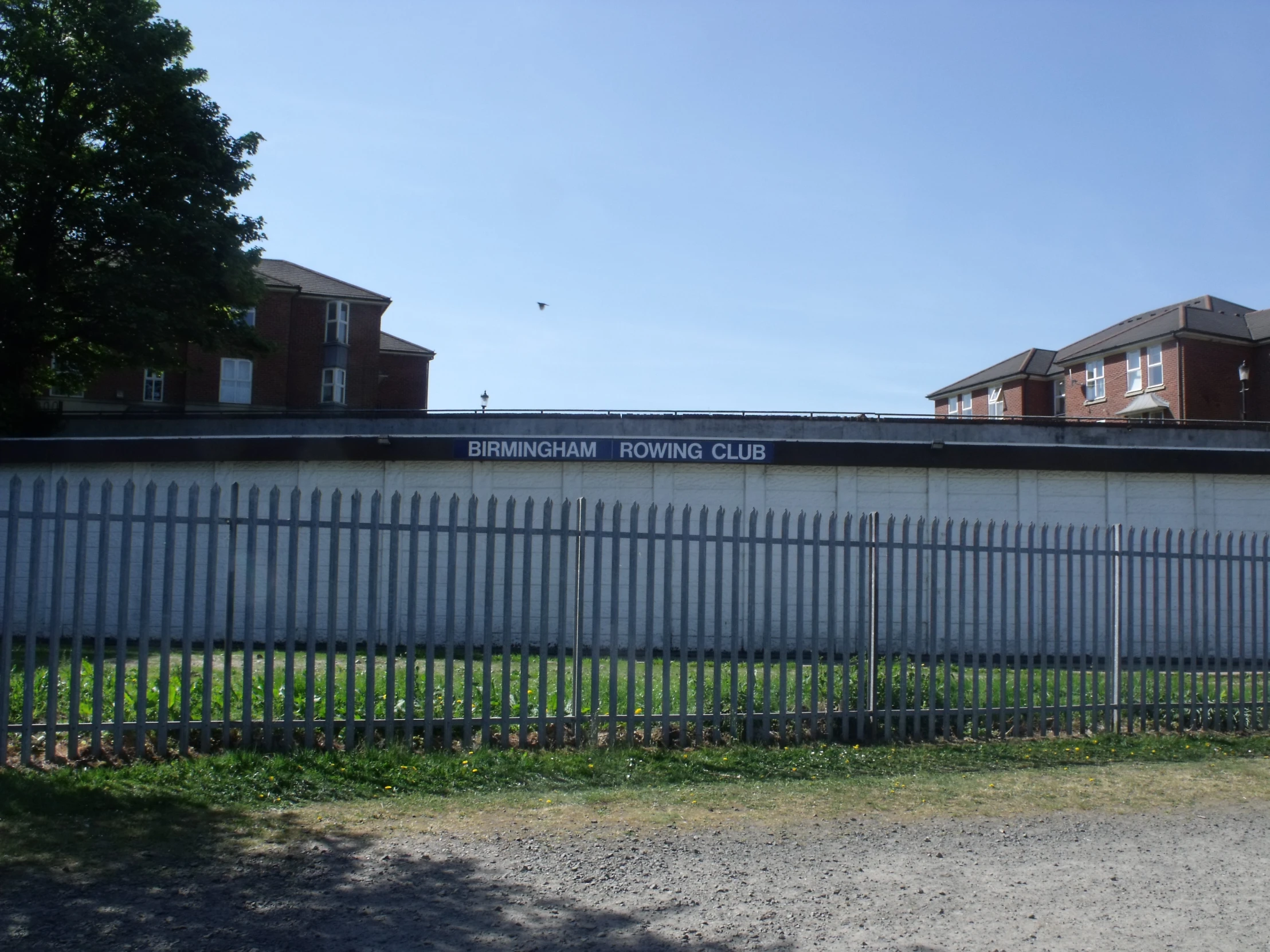 a fence in front of some large houses