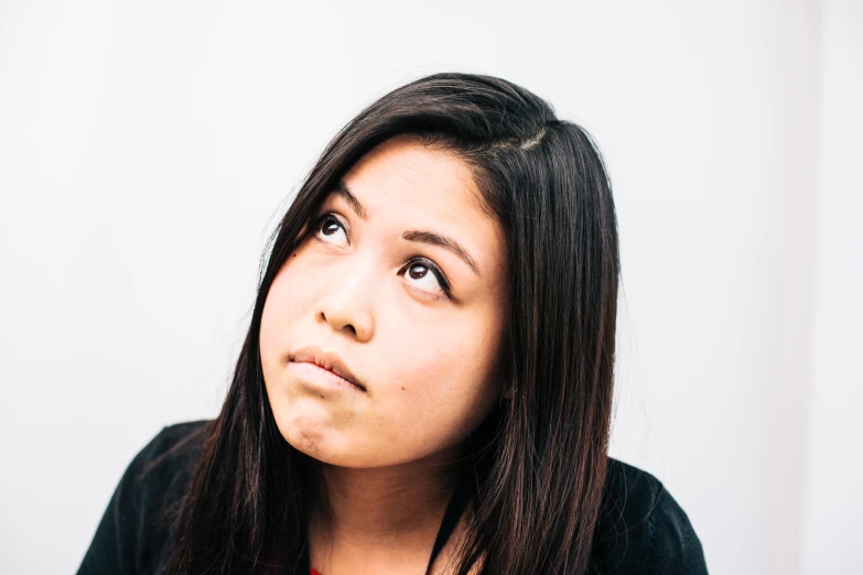 young woman with brown eyes looking up while leaning over