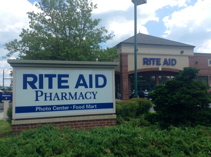 a rite aid pharmacy entrance with a large white sign in front