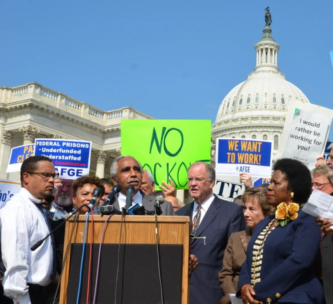 many people are gathered around the stage for a rally