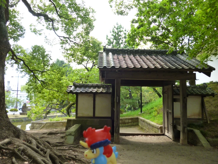 a small teddy bear in front of a gate