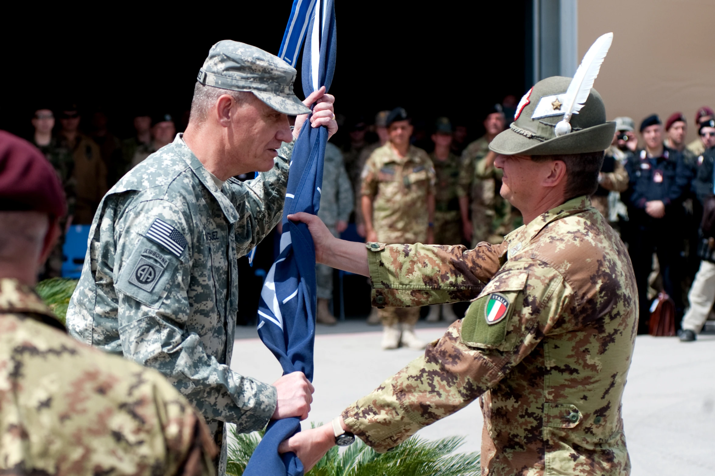 military men in uniform handing soing to someone