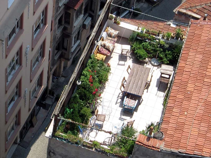 a roof garden has tables, chairs and flowers