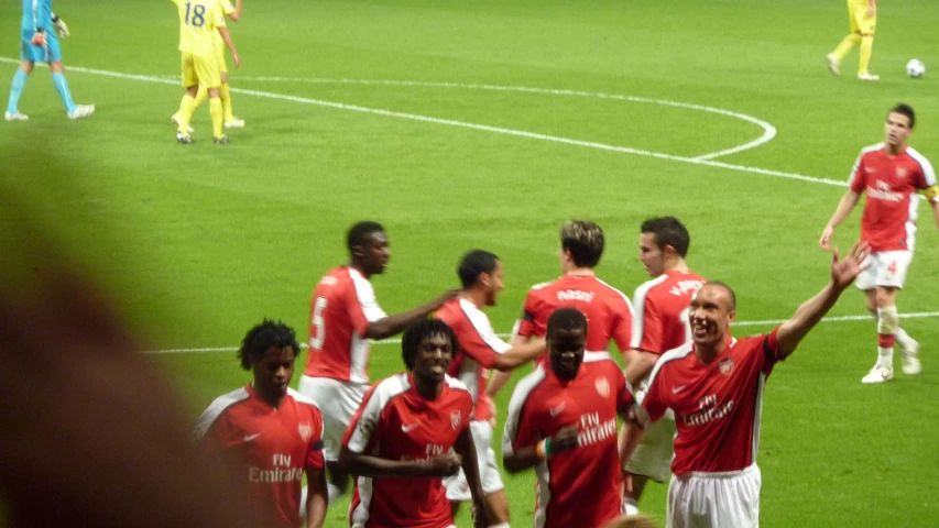 a group of soccer players is having a discussion