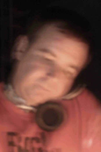 blurry image of a person wearing an orange shirt