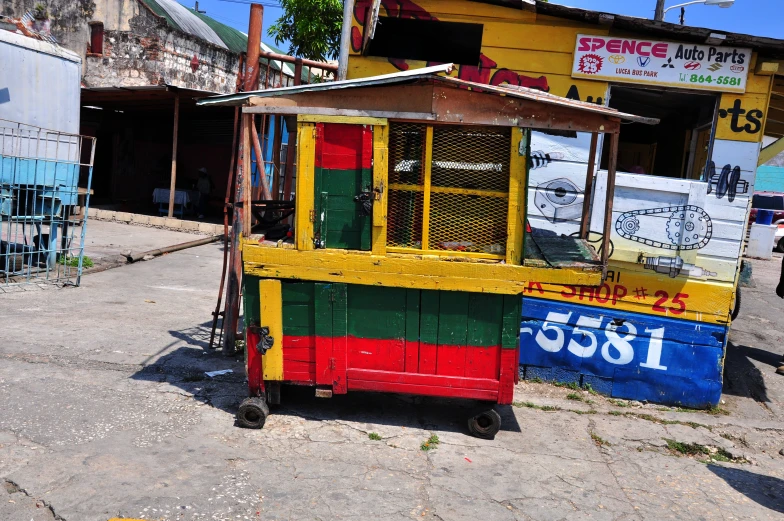 a food cart made from discarded boxes on the side of the street