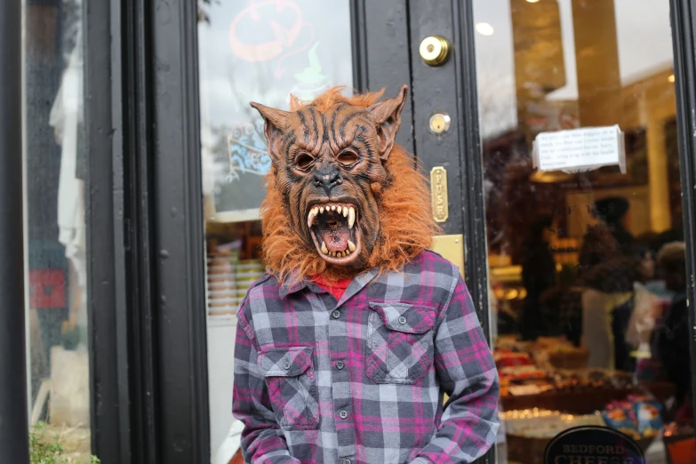 a creepy looking man wearing a red demon wig