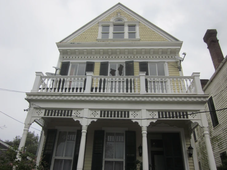 a very tall and pretty house with porches