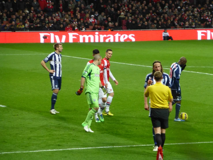 soccer players with referee watching on on field