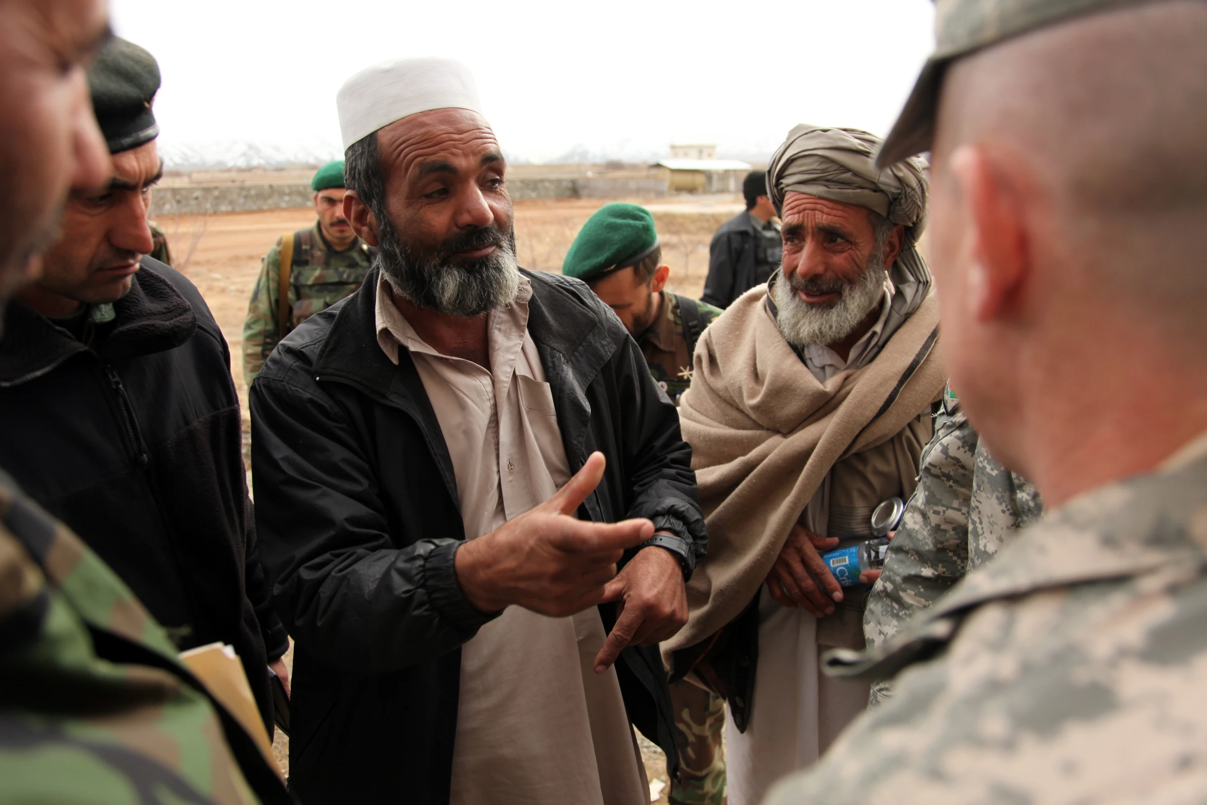 several men in military uniforms standing around each other