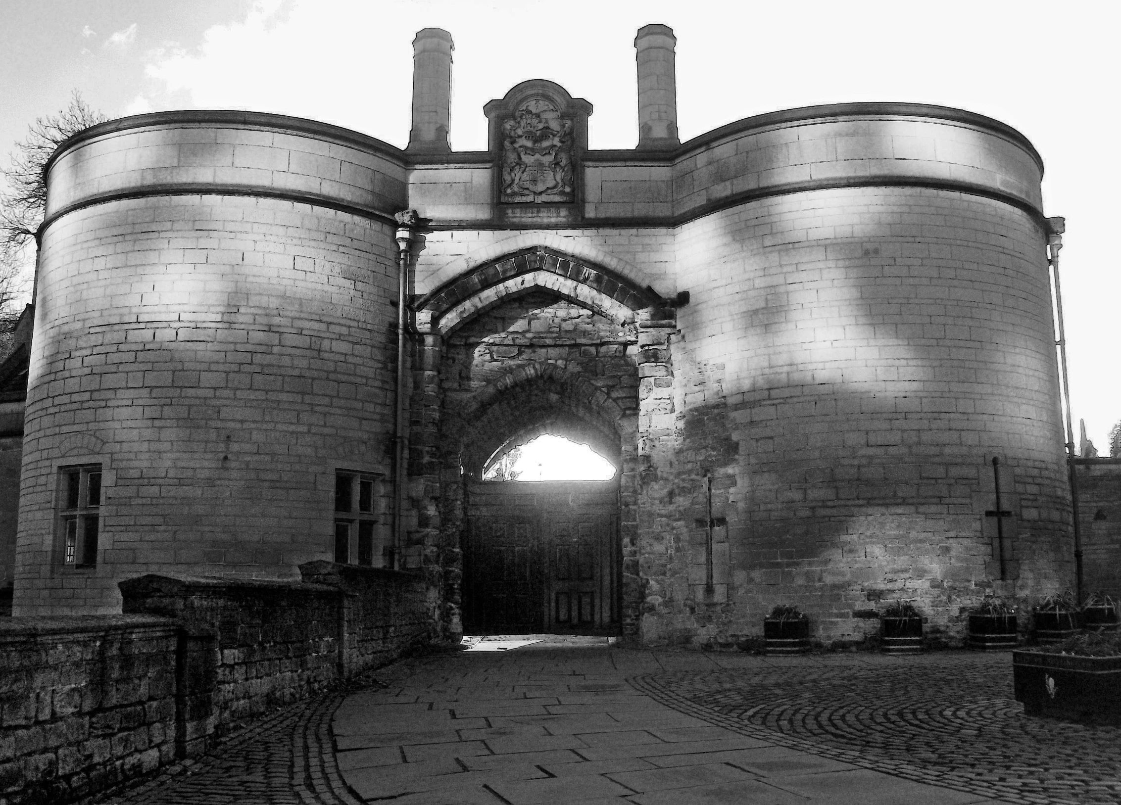 a brick castle with an arched entrance and a wall