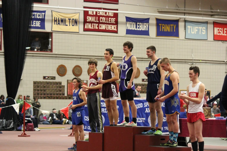 a group of young men on a stage receiving their medals