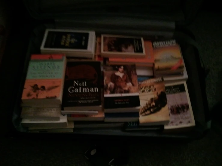 a suitcase has many different types of books in it