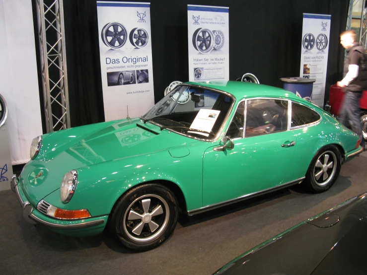 an older fashioned porsche car on display at a show