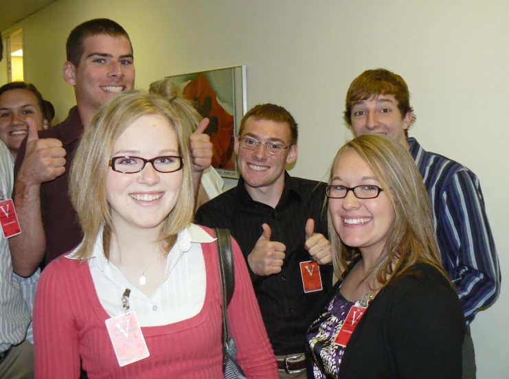 a group of people that are holding up their thumbs up