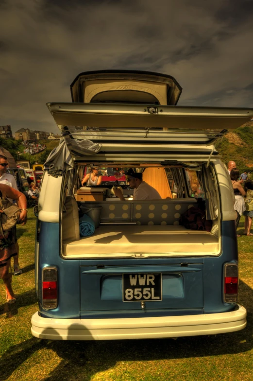 a group of people are in an old vw van