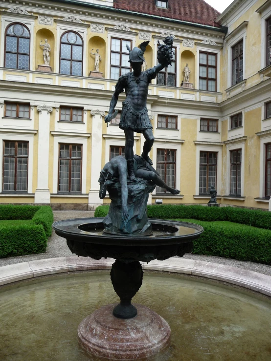 a water fountain with a sculpture in the middle