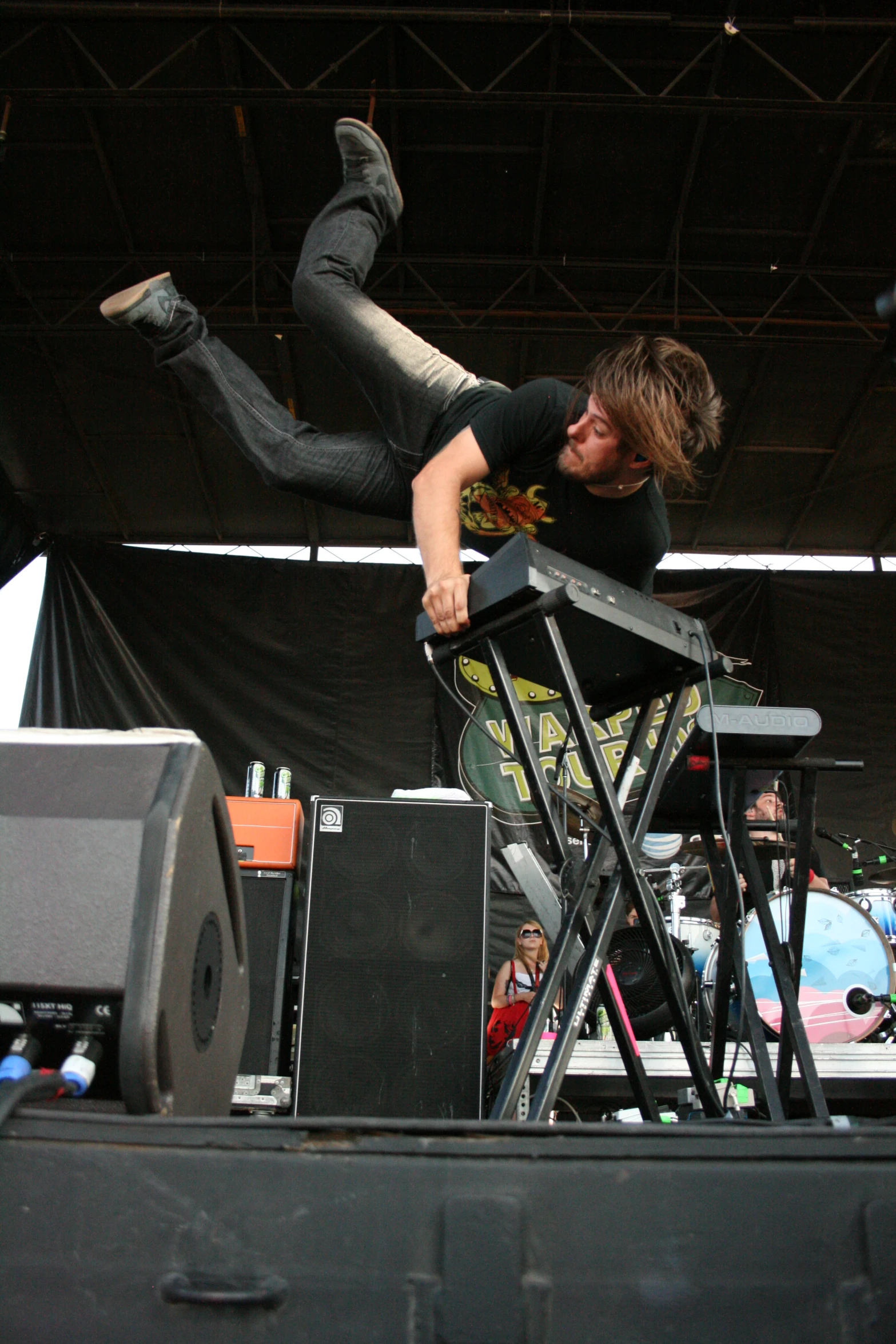 a man is jumping in the air with his feet up