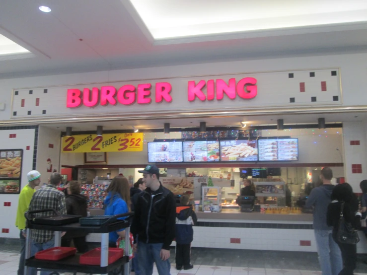 people standing in front of a restaurant with menus on the wall