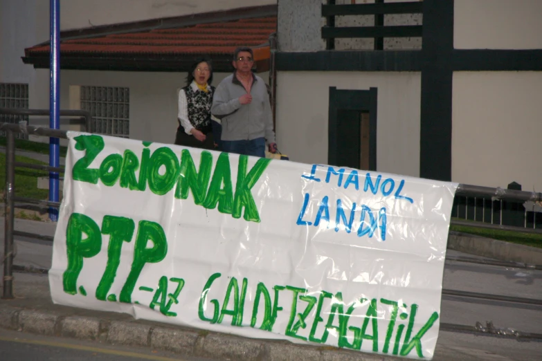 a man and woman are holding a sign saying zonjaak lanani pt12 - 12 - gad zegenaisk