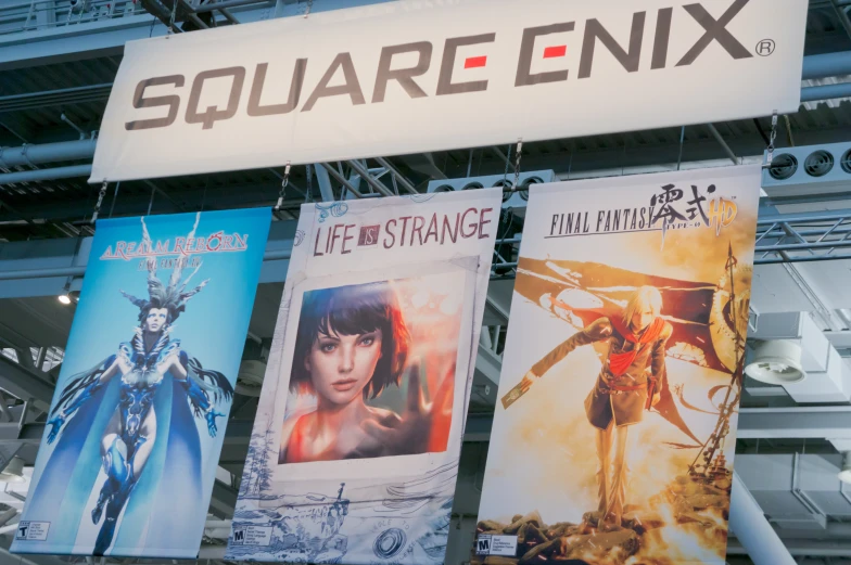 some posters are on display under the square enix sign
