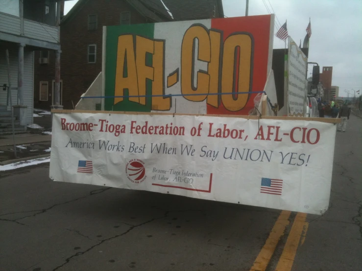 a labor sign in front of a large building