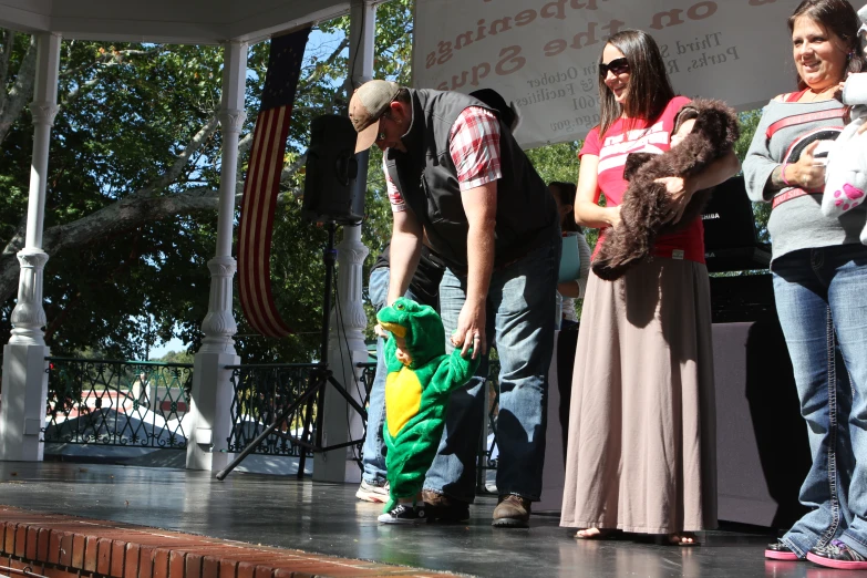 a group of people in costumes are on the stage with a child