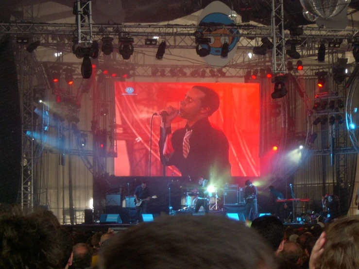 a concert scene at a concert with a singer on the screen