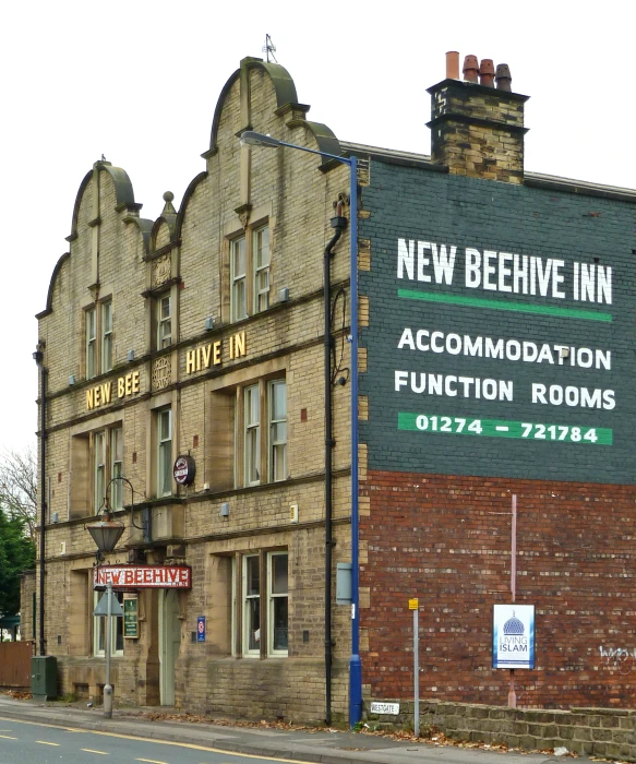 a large brick building is beside a street