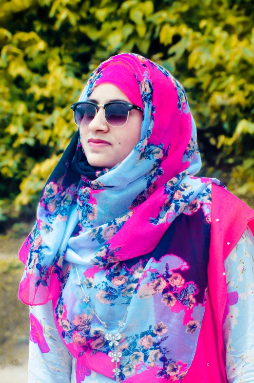 woman wearing sunglasses and floral print scarf on head