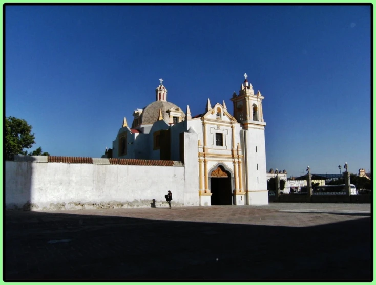 a small white building with towers and two small windows