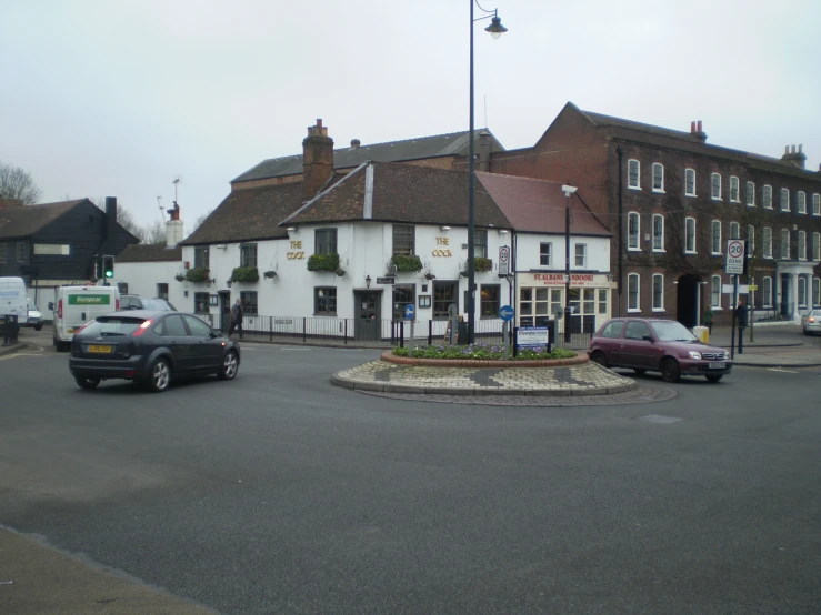 an intersection between two buildings with the front door open