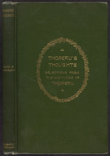 a book with words inscribed in gold on a dark green background