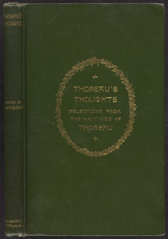 a book with words inscribed in gold on a dark green background