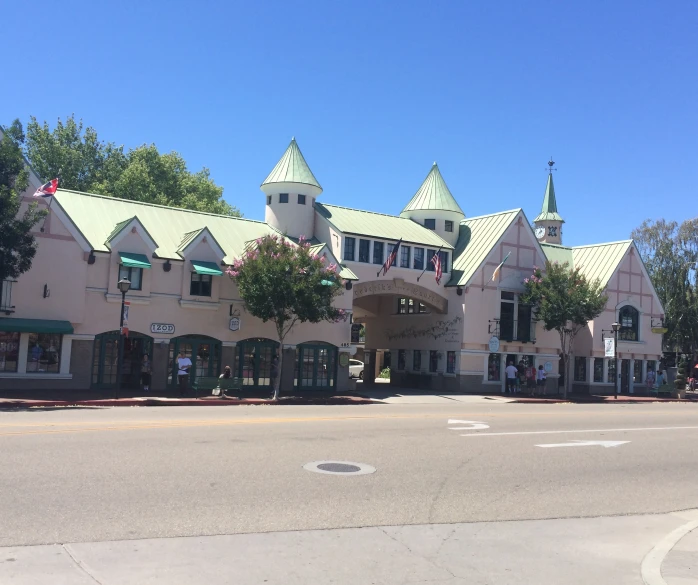 a building with lots of green roofing on top