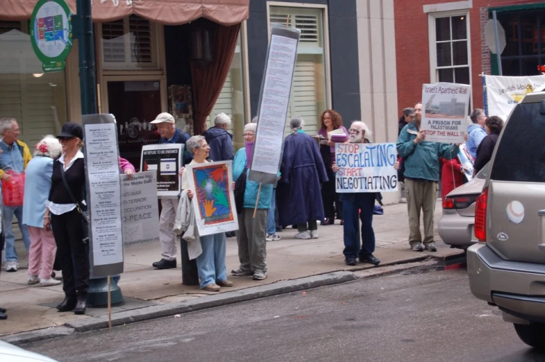 several people are standing outside with signs