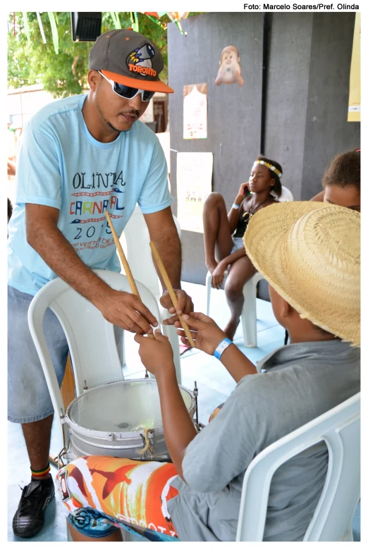 a man that is playing drums near a woman